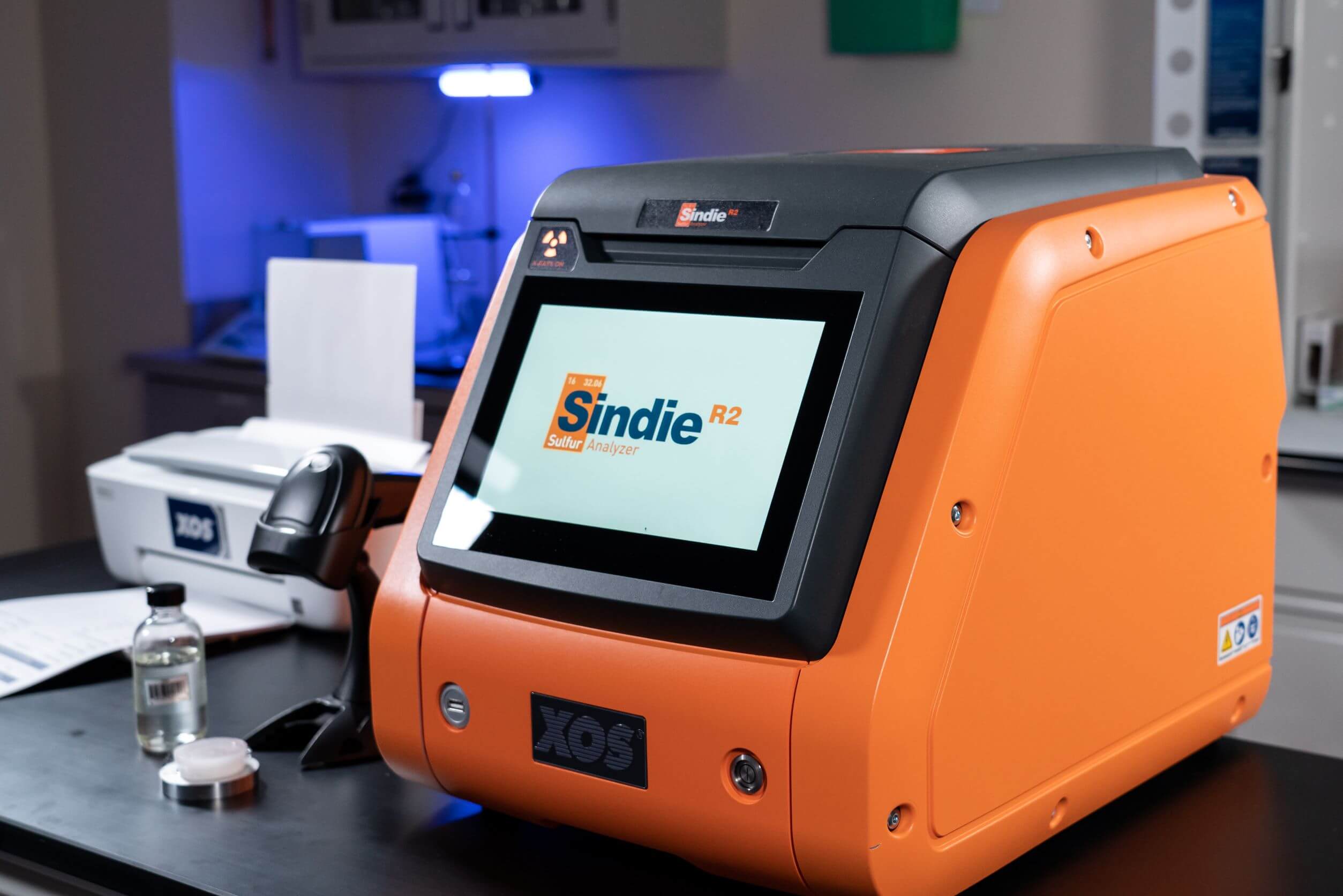 Sindie 2622 analyzer on a bench with Accucell cups and an open calibration vial.